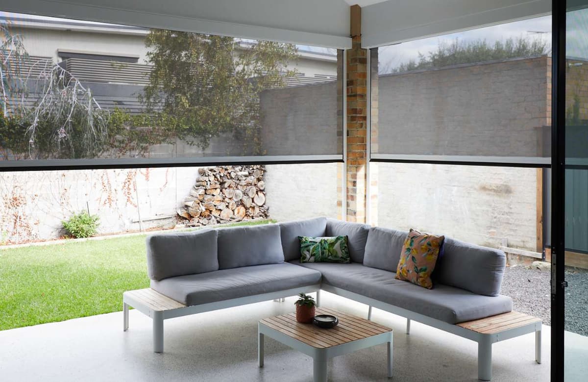 Vertical blind vanes angled to control light across a wide opening