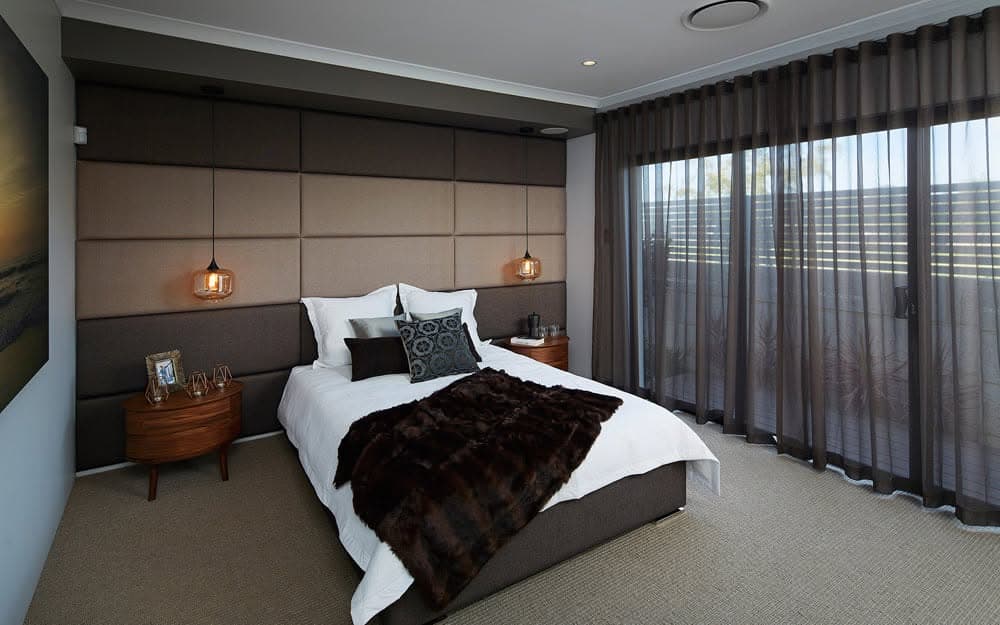 Floor-to-ceiling curtains drawn wall to wall in a dark contemporary bedroom