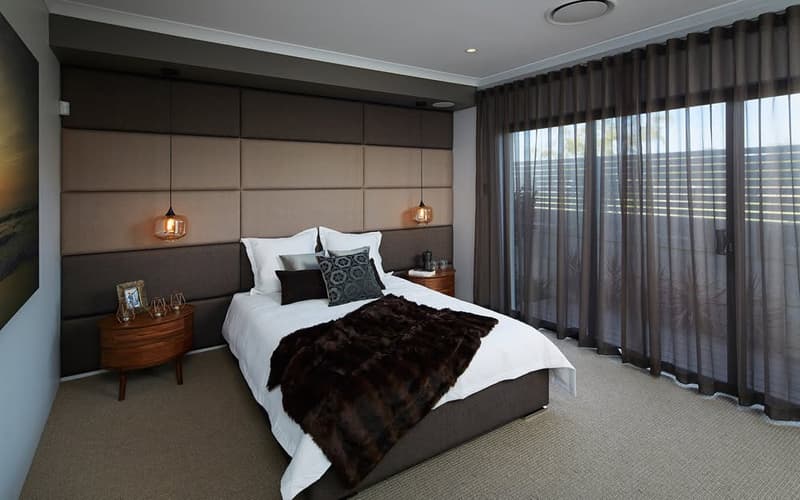 Charcoal sheer curtains hung wall to wall in a dark, contemporary bedroom