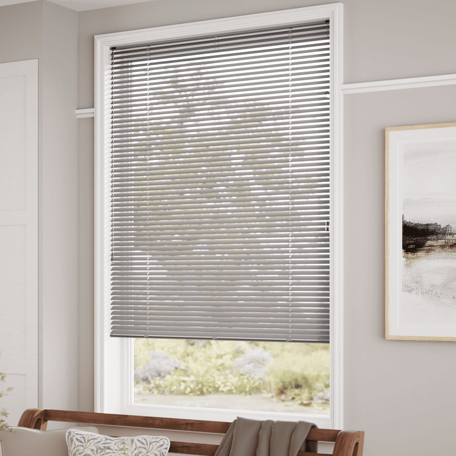 Grey aluminium Venetian blind with slats angled open across a bedroom window